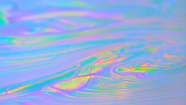 Holographic effect creates a colorful abstract pattern on a shiny surface