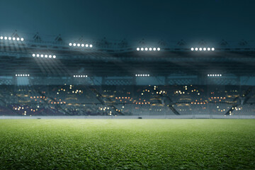 A low-angle shot of a lush green grass field in a large sports stadium at night, with bright floodlights illuminating the arena and blurred stands in the background © Leo Lintang