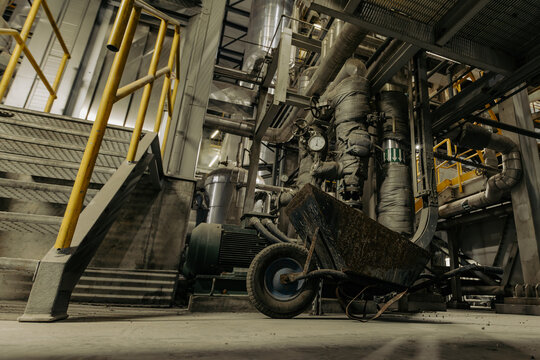 Industrial staircase with insulated pipes, valves and wheelbarrow