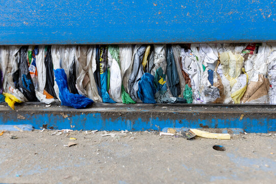 Compressed Plastic Waste Inside Recycling Press Machine at Waste Processing Facility