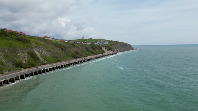 Forward Flying 4K Drone Shot Along Folkestone Promenade White Chalk Cliffs and Coastal Town Kent UK