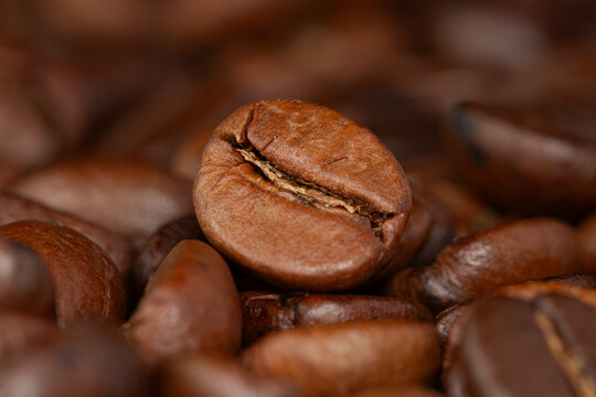 Roasted coffee beans pile , top view, close-up.
