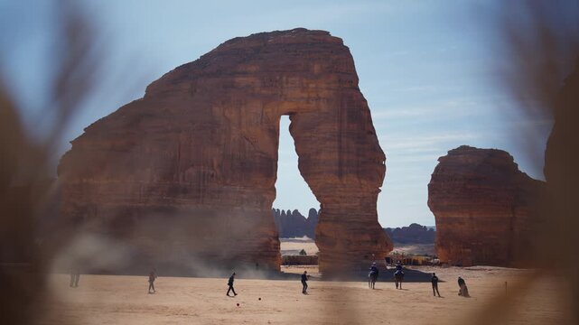 Slowmotion wide shot of Elephant Rock in Saudia arabia with tourists