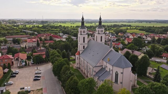 Drone orbiting Church of the Transfiguration, peaceful Polish countryside town