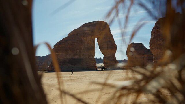 Slowmotion push in shot of Elephant Rock in Saudia arabia with tourists