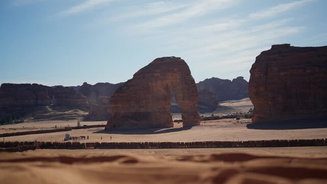 Reveal Slowmotion wide shot of Elephant Rock in Saudia arabia with tourists