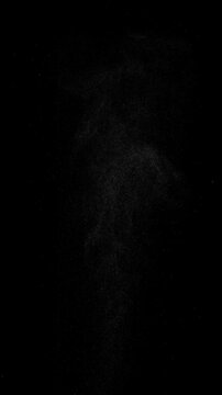 Hot Steam Plume Rising on Black. Vertical slow-motion of hot white steam powerfully rising from below, forming a tall turbulent column that expands, swirls and gradually dissipates into fine sparkling