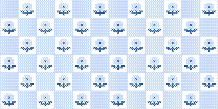 Seamless light blue cross stitch pattern featuring floral motifs in a checkered grid.