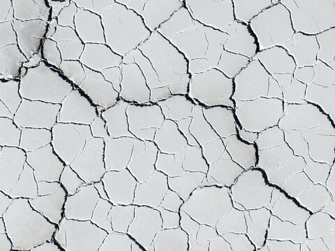 Aerial view of the cracked white surface and hexagonal patterns of the Uyuni Salt Flat in Potosi Department, Bolivia.