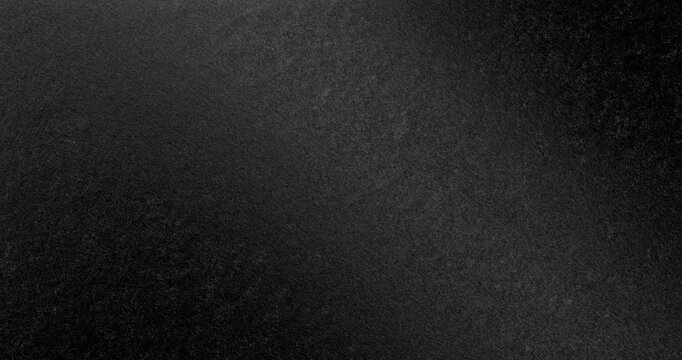 Dark Rough Texture Seamless Loop. Subtle continuous movement across a deep black rough textured surface with fine grain and soft light gradients. 