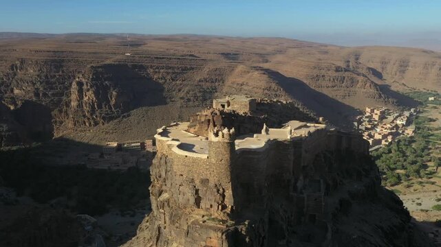 Ancient Earthen Fortress Perched on Rocky Cliff Face

