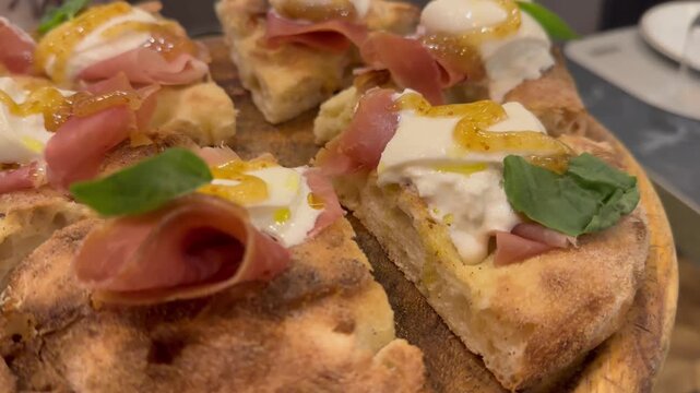 a delicious pizza with stracciata, prosciutto, and fig jam