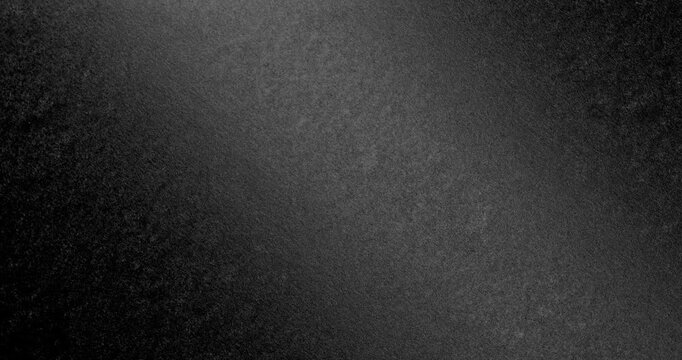 Dark Rough Texture Seamless Loop. Subtle continuous movement across a deep black rough textured surface with fine grain and soft light gradients. 