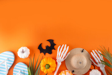 Summerween holiday background. Bright festive background for summer Halloween holiday in style of Halloween with summer decorations, pumpkins, ghost, bat, summer vacation accessories, tropical leaves © ricka_kinamoto