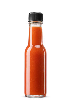 Hot sauce in a small clear glass bottle with a black cap isolated. Transparent PNG image.
