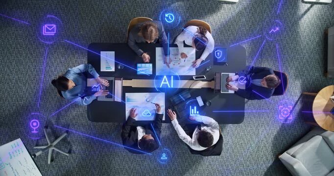 Top Down View of Business Professionals Collaborating Around Office Table With Laptops and Charts as Linked Visualization Layer Appears, Glowing Blue AI Icons Represent Data Analytics and Security.
