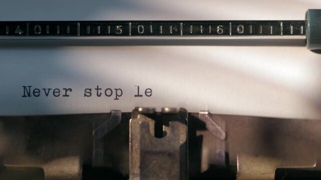 Message typed on a typewriter encourages people to keep learning throughout life. Never stop learning
