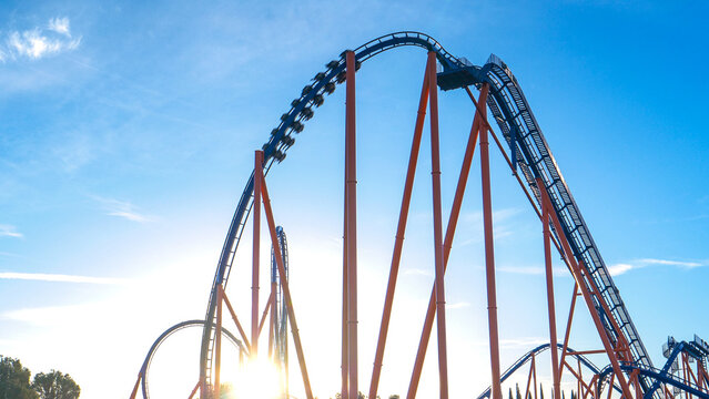 LENS FLARE: Golden sunbeams shine on the massive loop of a roller coaster ride