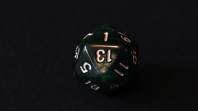A D20 dice shows a natural one as a light source moves and reflects off of the surface.