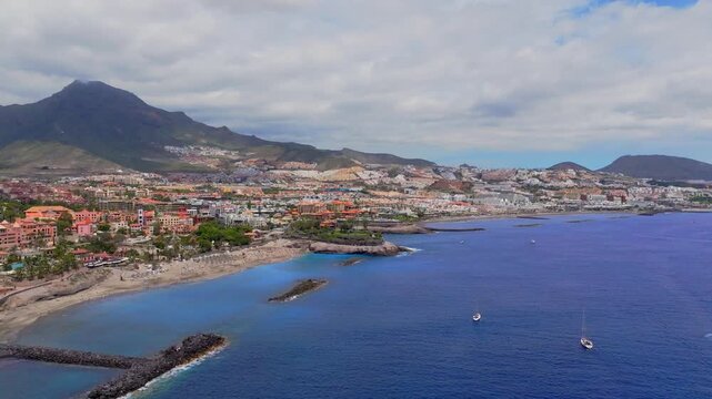 Aerial view of Playa del Duque coastline with mountains and resorts in Tenerife, Spain