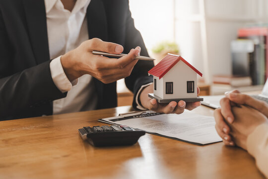 Hand of landlord, realtor pointing sign signature contract rental, purchase, buyer home or apartment with tenant, client after banker agreement mortgage, loan success or done. Property agent concept.