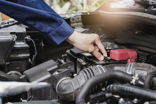 Auto check up and car service shop concept. Mechanic writing job checklist to clipboard to estimate repair quotation to client at workshop garage.