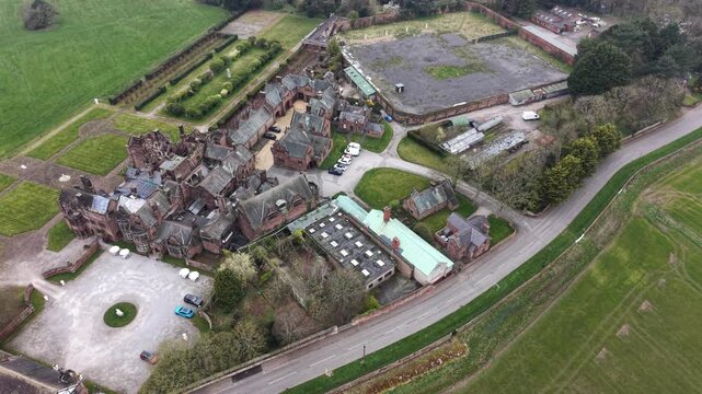 Aerial video showing farmland fields beside tree covered countryside.