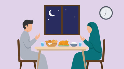 Fototapeta premium Muslim couple praying before Iftar meal at home during Ramadan night