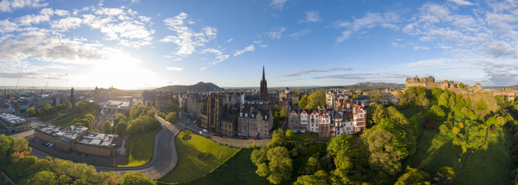 Aerial view of Edinburgh Castle and the historic city skyline with stone architecture and lush green parks under a bright morning sun Edinburgh, Scotland, United Kingdom.