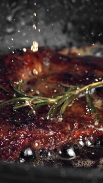 Beef steak in a pan with garlic and spices. Filmed on a high-speed camera at 1000 fps. High quality FullHD footage