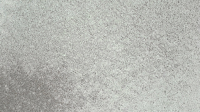 Aerial view of the vast salt crust patterns of Salinas Grandes with intricate hexagonal textures under bright daylight in Tumbaya, Jujuy, Argentina.