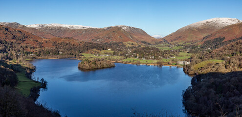 Naklejka premium Grasmere from Loughrigg Terrace looking towards Helm Crag and Rydal Fell in winter with snow on summits sunny day no people