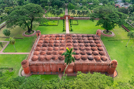 Aerial view of the Sixty Dome Mosque with its numerous terracotta domes, lush green gardens, and surrounding trees in Bagerhat, Khulna Division, Bangladesh.