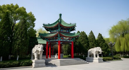 Fototapeta premium A beautiful traditional Chinese pavilion with a green roof and red pillars stands with elephant statues