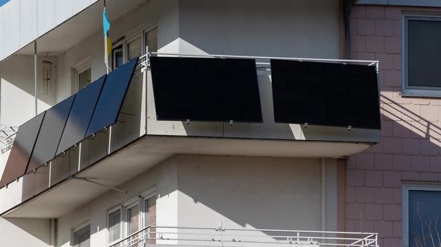 Balcony solar panels generating renewable energy on an apartment building facade