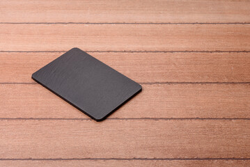 Fototapeta premium An empty slate cutting board for preparing ingredients for home cooking. An empty cutting board