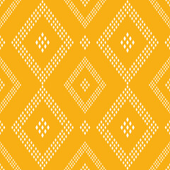 geometric pattern with white dotted diamonds on a yellow background. Geometric ethnic pattern.  © JRW_12