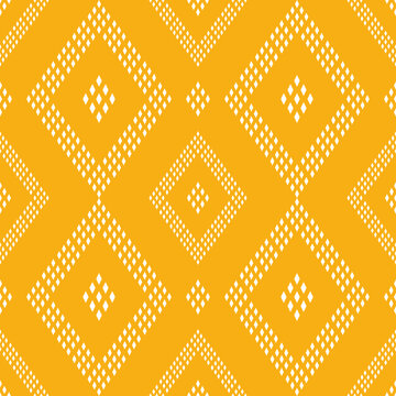 geometric pattern with white dotted diamonds on a yellow background. Geometric ethnic pattern. 
