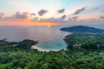 Naklejka premium Aerial view of a serene Merlin Snorkel Bay in Phuket Thailand at sunset