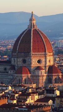 vertical video, orbiting drone shot of Florence old town with the setting sun, Italy, Florence Renaissance cathedral Santa Maria del Fiore at sunset aerial video, travel in Tuscany, Italy