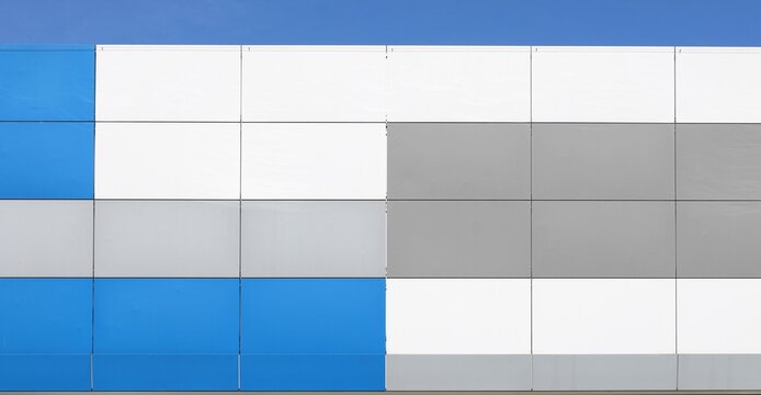White, blue and gray aluminium composite panels of a modern ventilade facade. Background and texture.