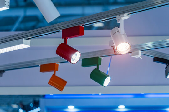 Directional LED lights on rails under the ceiling in a modern warehouse, shopping center building, office or other commercial real estate object.
