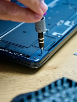 Hands Repairing Opened Laptop