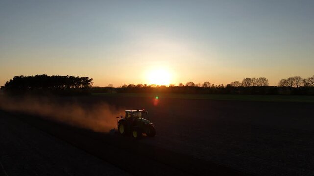Drone escort behind tractor through glowing haze