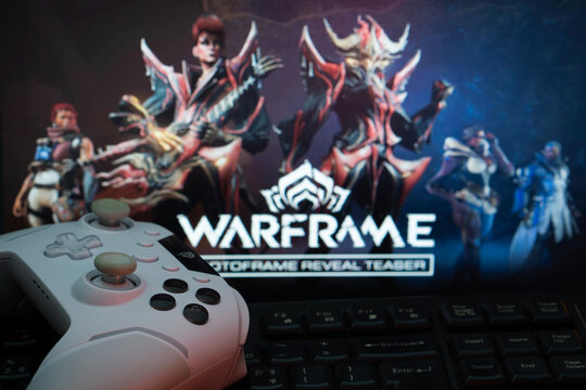 Dhaka, Bangladesh- 08 Apr 2025: A game controller and keyboard in front of a Warframe Game screen.