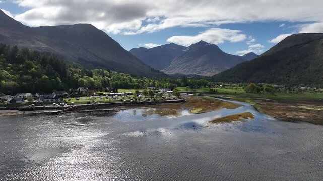 Sunny Aerial Flight Over Loch Leven Towards River Mouth with Glencoe Mountains, Campsite and Vibrant May Colours