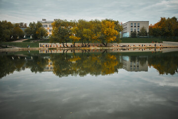 Fototapeta premium View of landscaped embankment around large Konkovsky pond. Konkovo District, Moscow