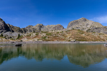 Fototapeta premium Scenic alpine view of Longuet lake surrounded by mountains in the Belledonne massif ,French Alps
