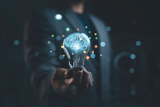 Creative artificial intelligence and innovation concept with glowing brain inside light bulb. Business technology, smart thinking, digital transformation and AI solution development concept.