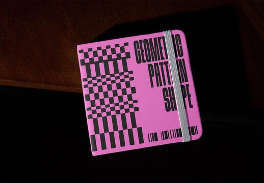 Mockup of a Simple White square Notebook front cover on a Table